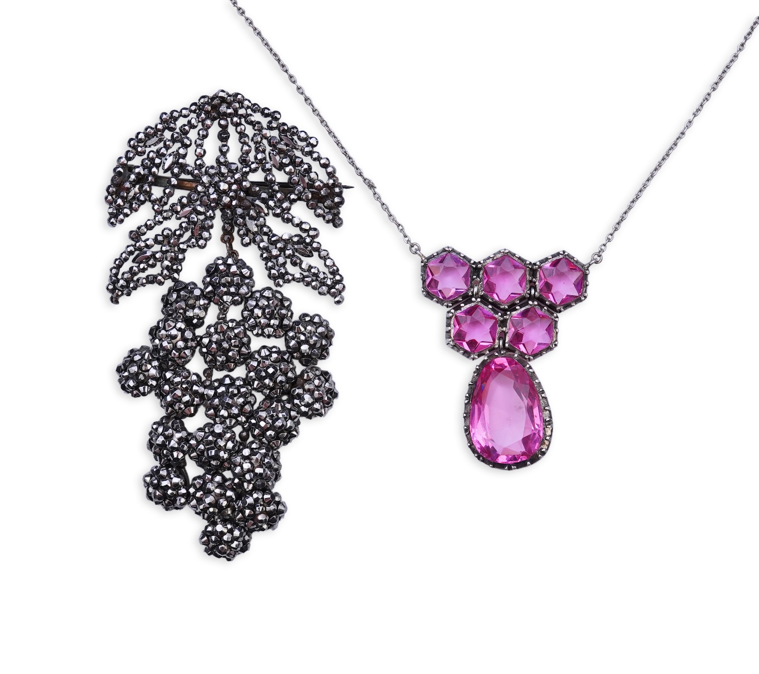 A cut steel brooch, 19th century, and a pink paste pendant